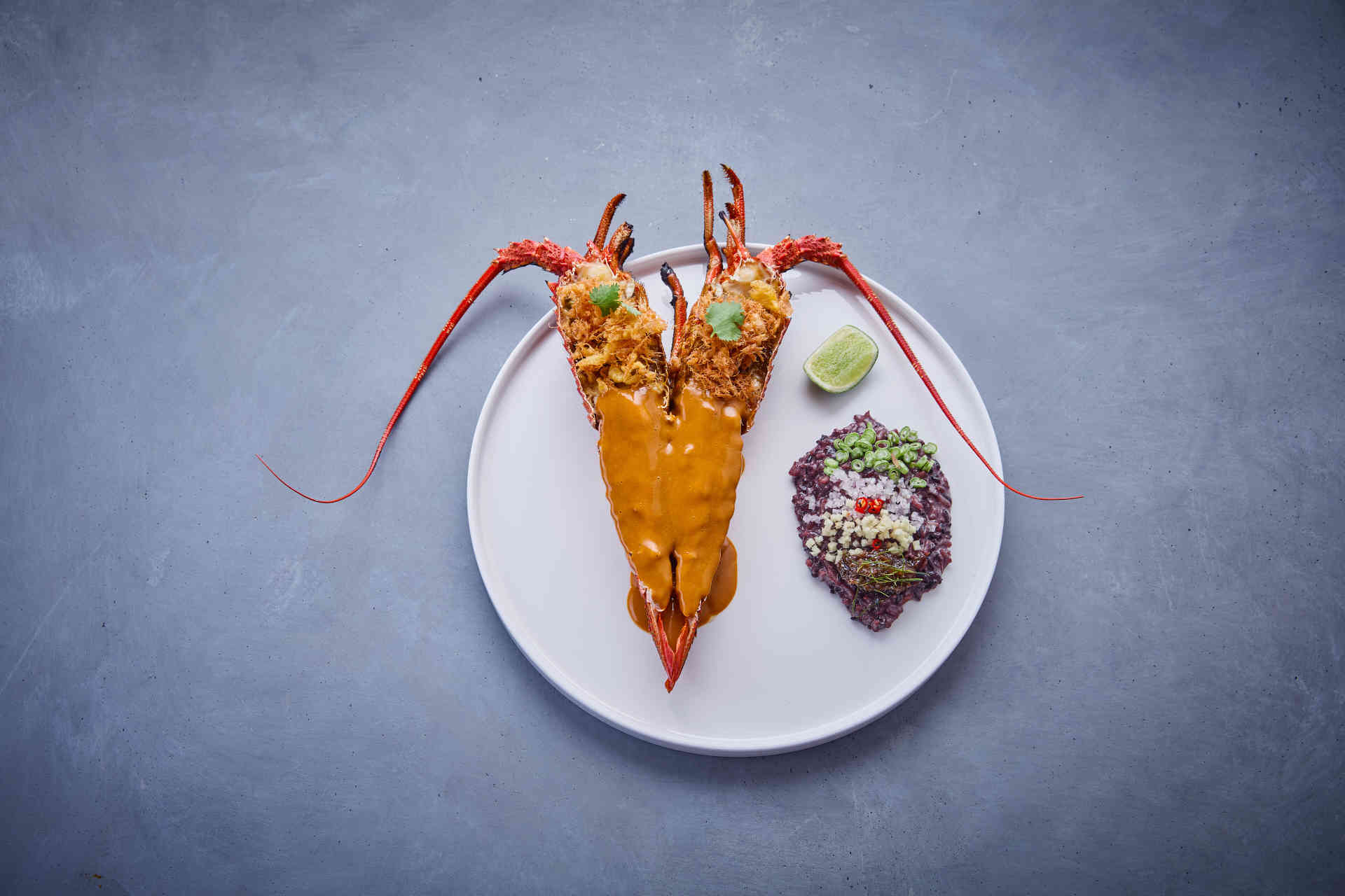 Crayfish, tom yam bisque, crispy egg and black rice © Helge Kirchberger Photography
